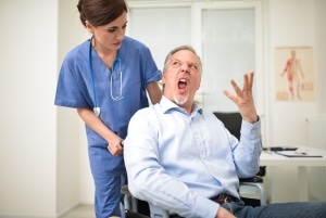 Female nurse with a disgruntled male patient