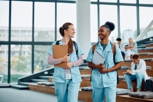 Two smiling medical students in a lecture hall
