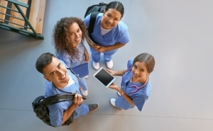 Overhead view of smiling medical students in a hallway
