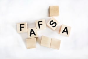 FAFSA is spelled in wooden blocks against a white background