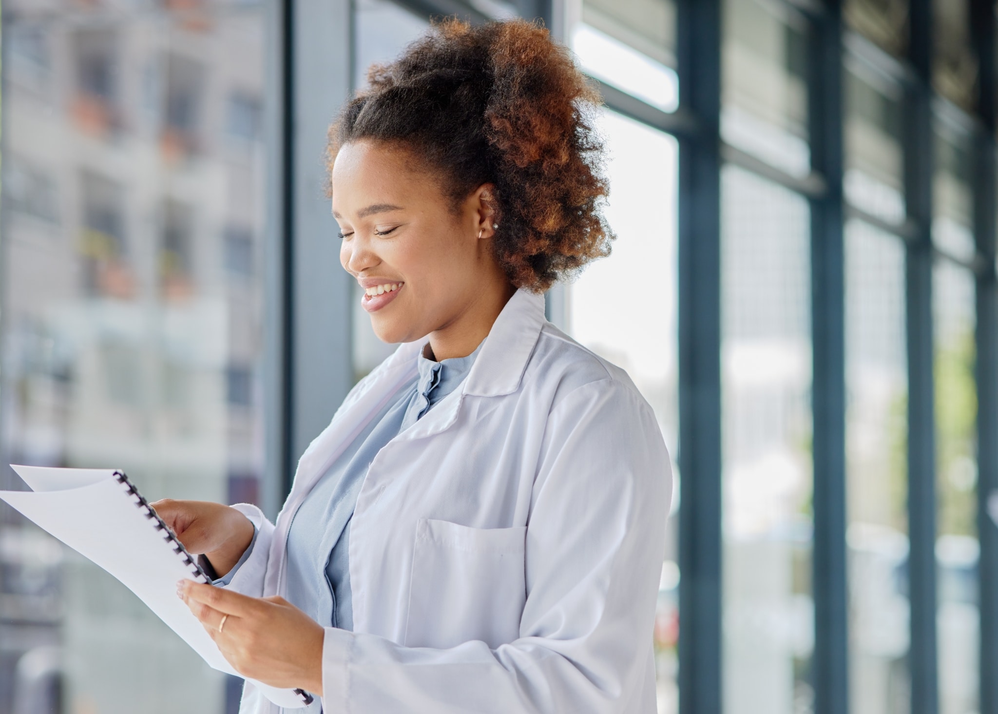 African-American medical professional looking at her notes
