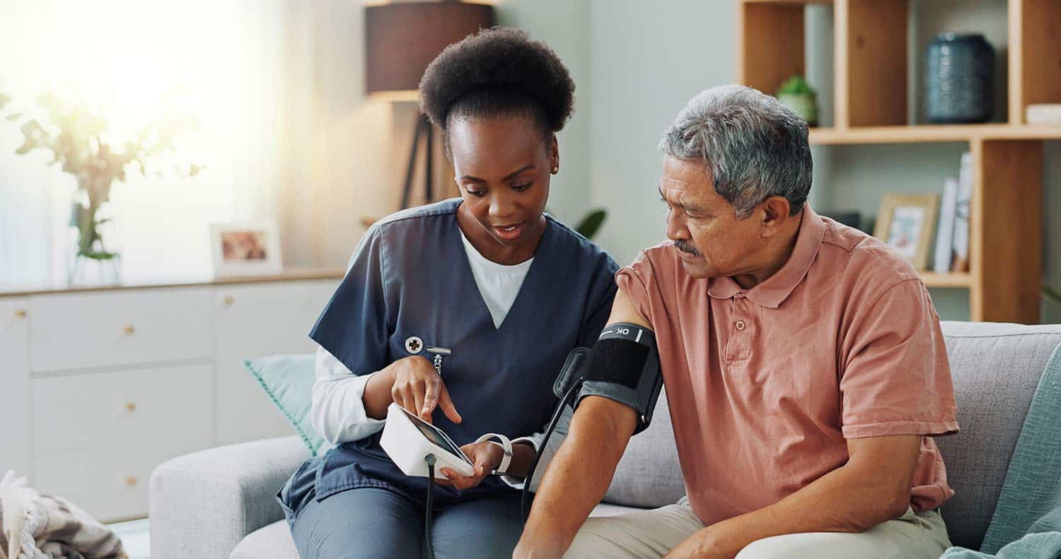 African-American nurse showing a patient their blood pressure results